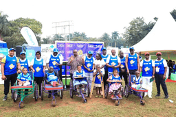 Hon.-Dr.-Balaam-Barugahara-Ateenyi-Cposes-for-a-photo-with-CoRSU-staff-and-children-with-disabilities